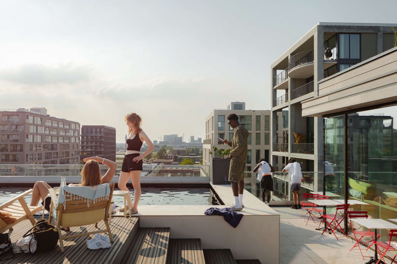 Residents on the rooftop pool deck of Republica, Amsterdam-Noord