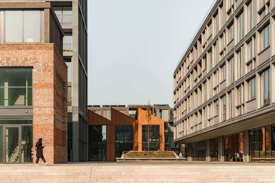 An alley between the Corten steel office building and the brick buildings